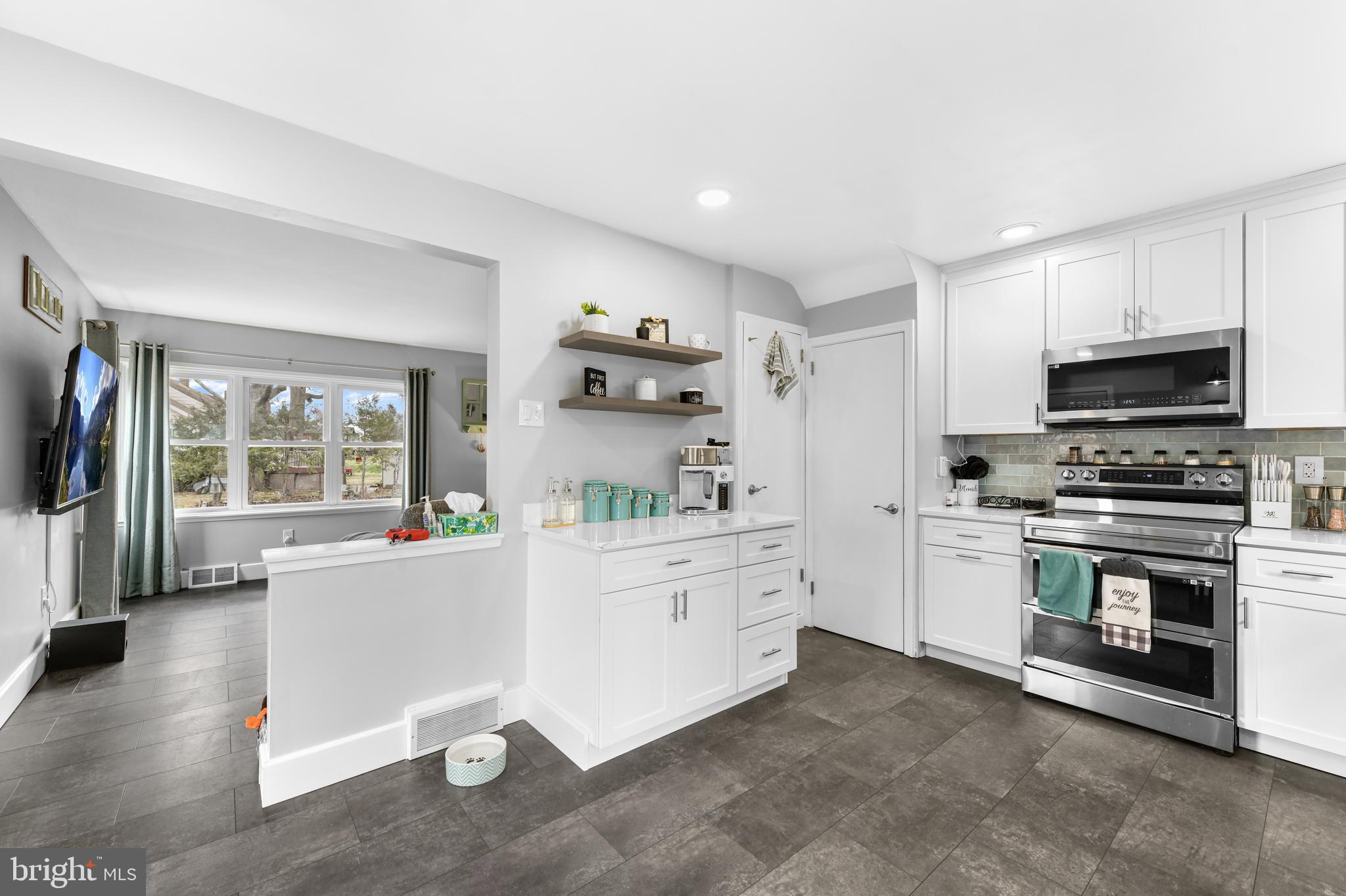 203 Eric Avenue Reading, PA 19607 - Photo 4 of 46 a kitchen with granite countertop a stove a sink and a refrigerator