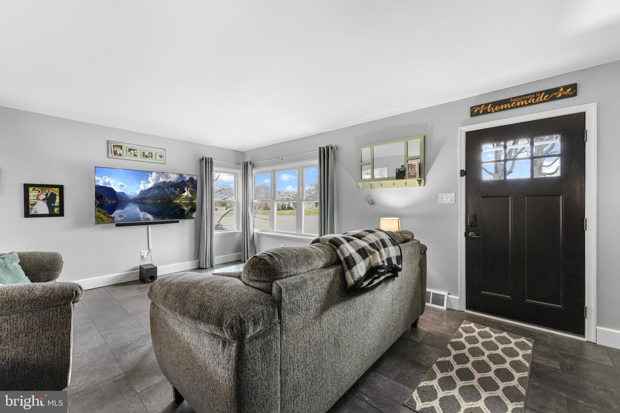 203 Eric Avenue Reading, PA 19607 - Photo 7 of 46 a living room with furniture and a flat screen tv