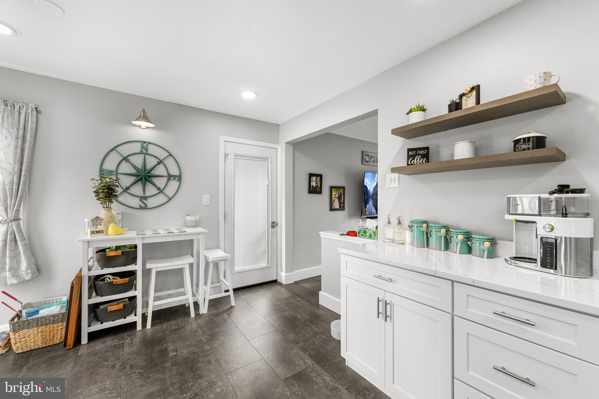 203 Eric Avenue Reading, PA 19607 - Photo 10 of 46 a kitchen with stainless steel appliances a white stove top oven and a wooden floors