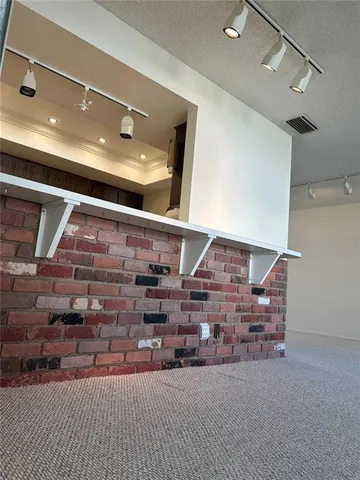 a living room with hard wood floors and a fireplace