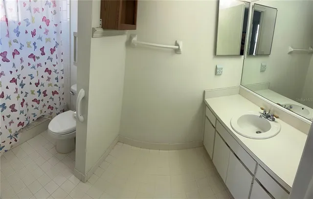 a view of a bathroom with a sink and a mirror