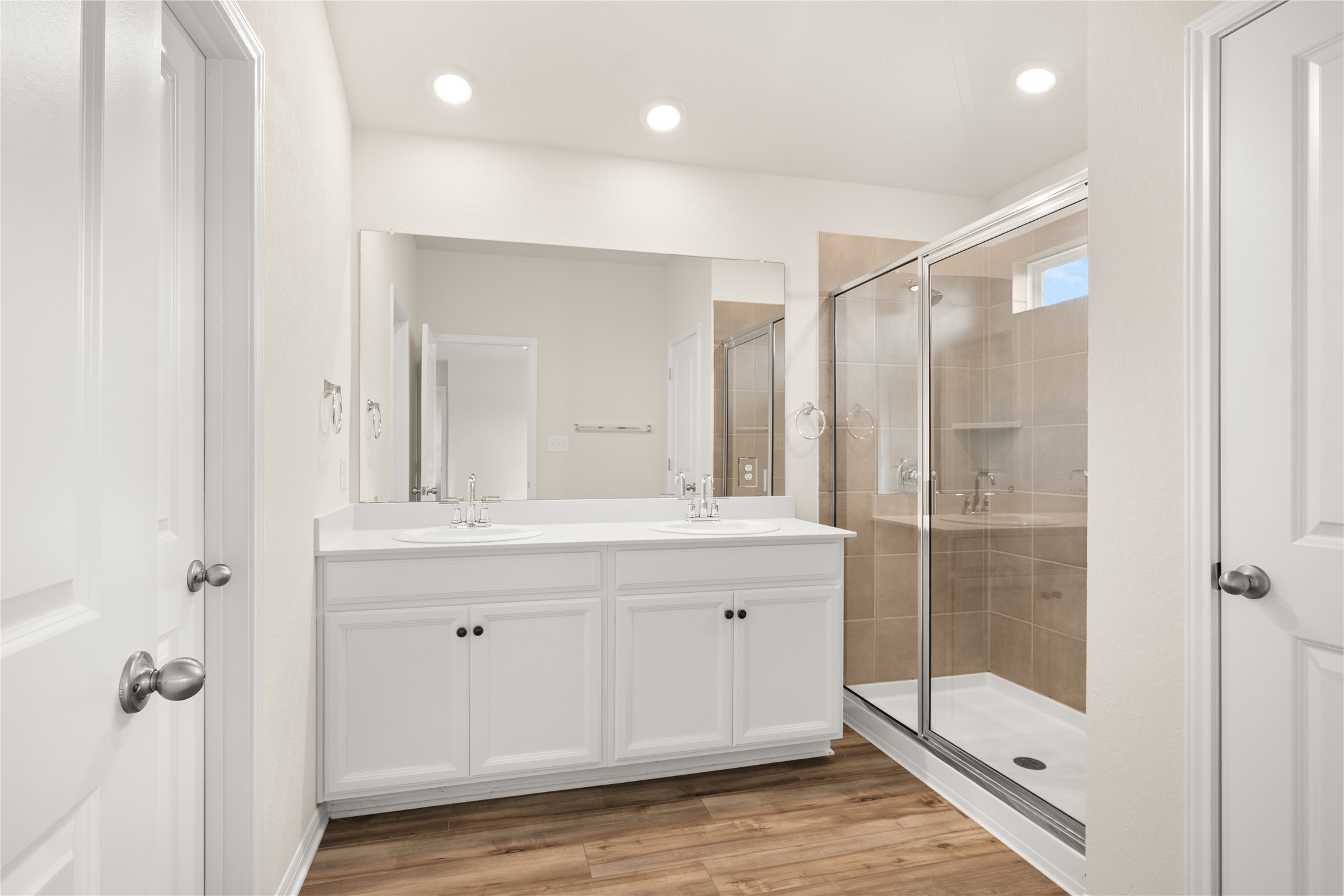 105 Saviano Road Hutto, TX 78634 - Photo 10 of 22 Dual vanities and a spacious glass-enclosed shower create a pristine bathing experience.