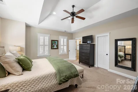 a bedroom with a bed a dresser and a window