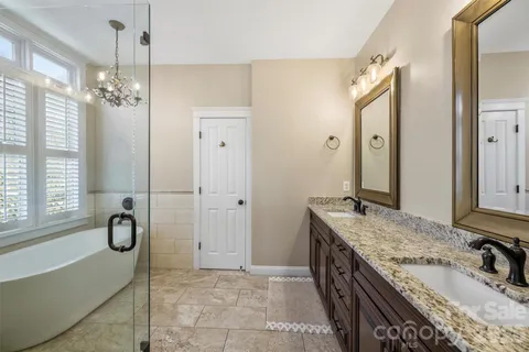 a spacious bathroom with a granite countertop sink and a mirror