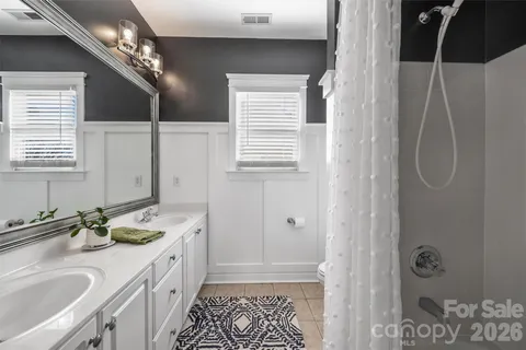 a bathroom with a double vanity sink and a mirror