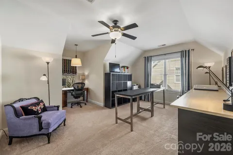 a work room with furniture and a large window