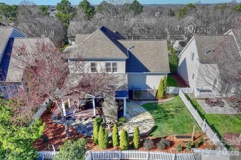 an aerial view of a house with a yard and potted plants