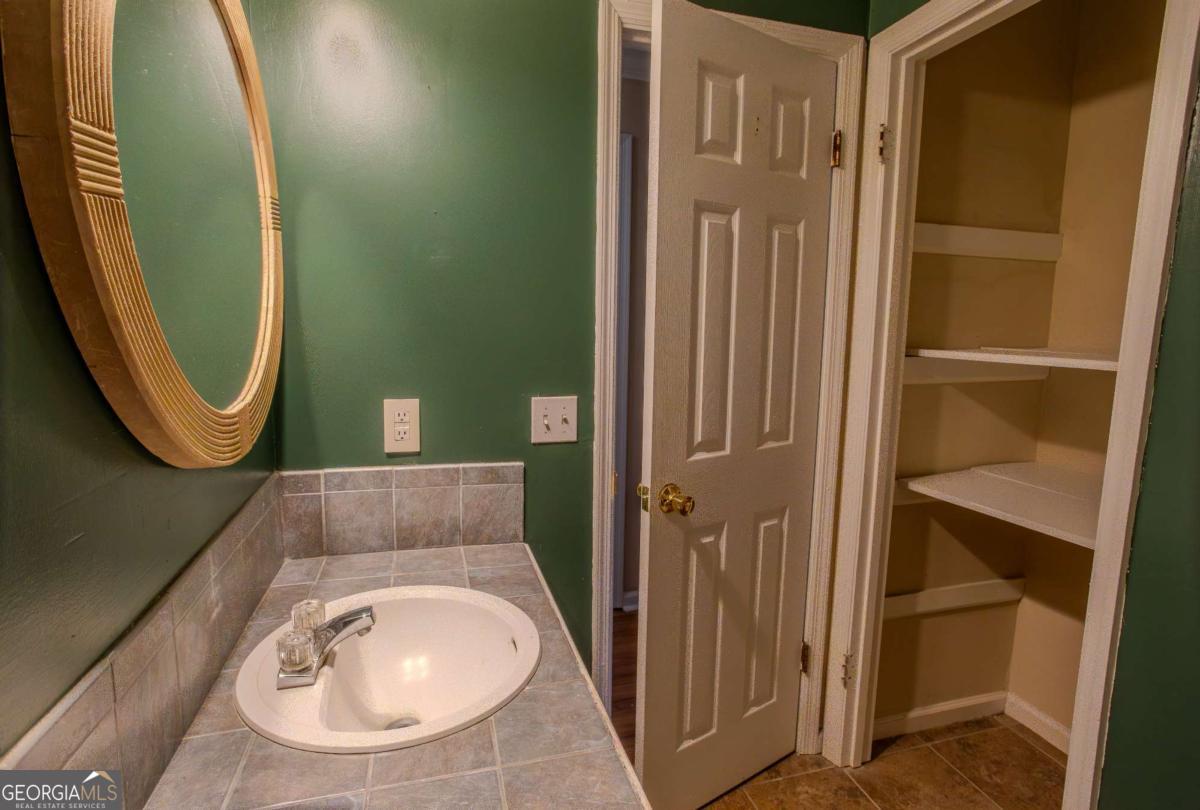 121 Trapper Trail Blackshear, GA 31516 - Photo 17 of 21 a bathroom with a sink a toilet and a mirror