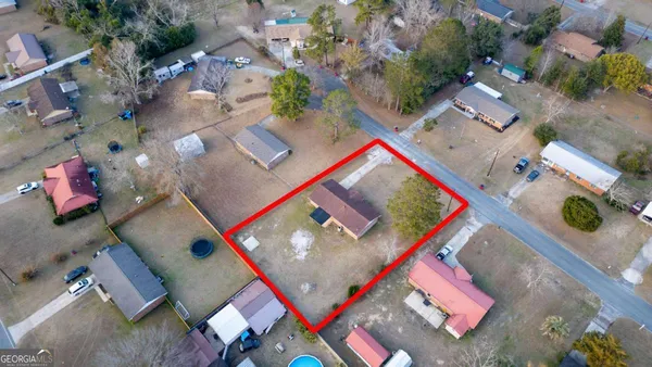 an aerial view of residential house with outdoor space and parking