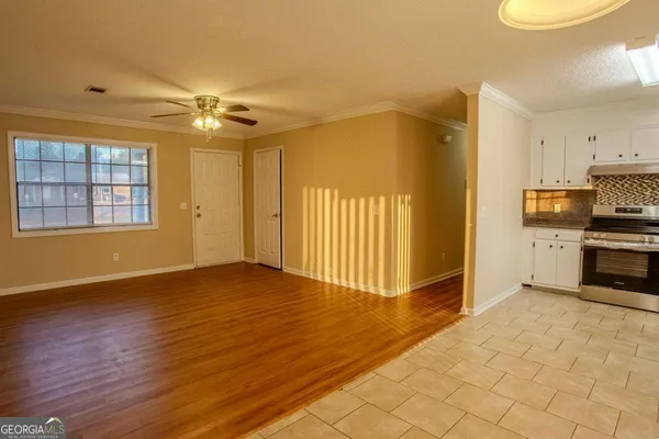 a view of a kitchen with kitchen appliances and wooden floor