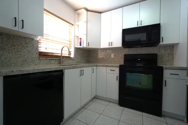 a kitchen with a sink stove and microwave