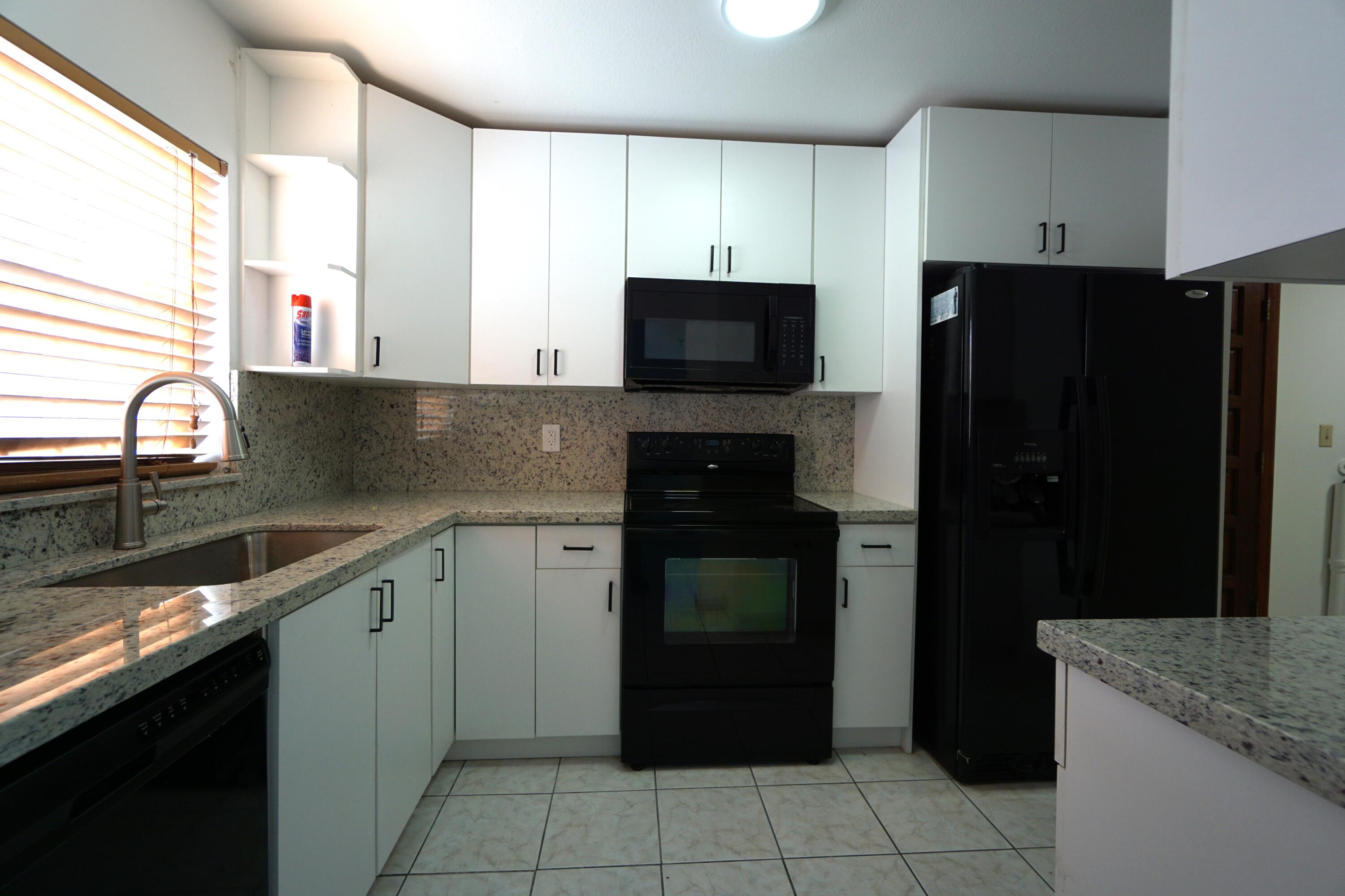 15520 Southwest 302nd Street Homestead, FL 33033 - Photo 17 of 20 a kitchen with a refrigerator and a sink