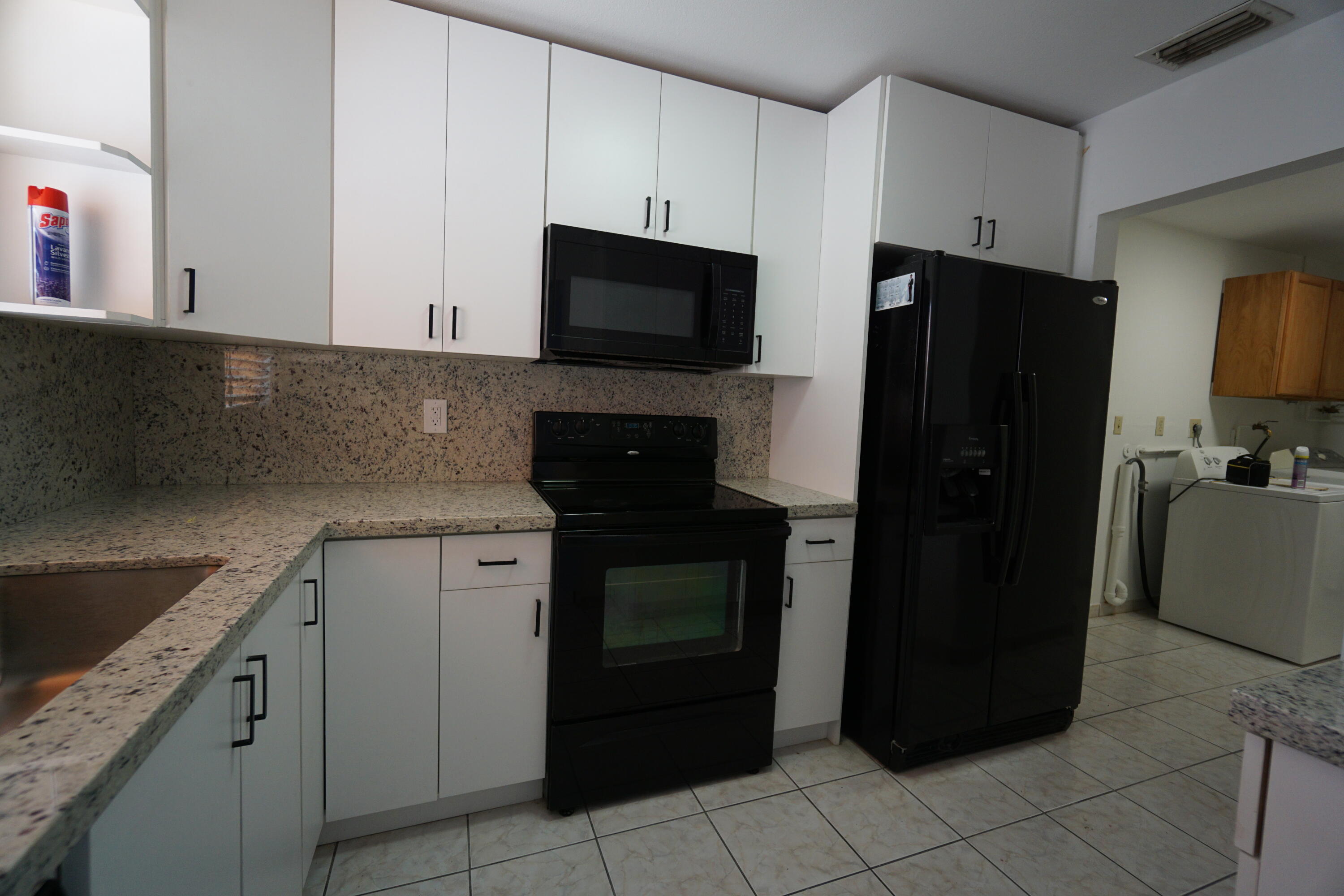 15520 Southwest 302nd Street Homestead, FL 33033 - Photo 18 of 20 a kitchen with a refrigerator stove and cabinets