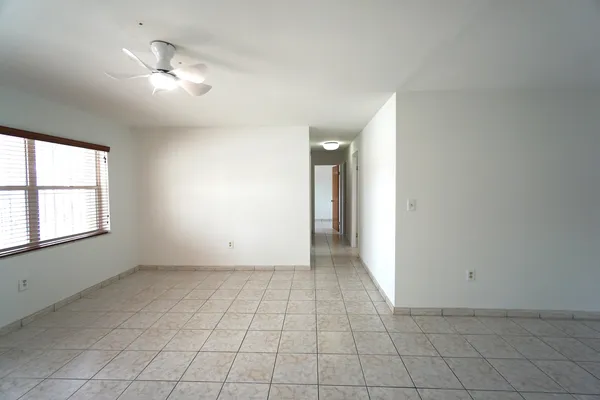 an empty room with windows and closet
