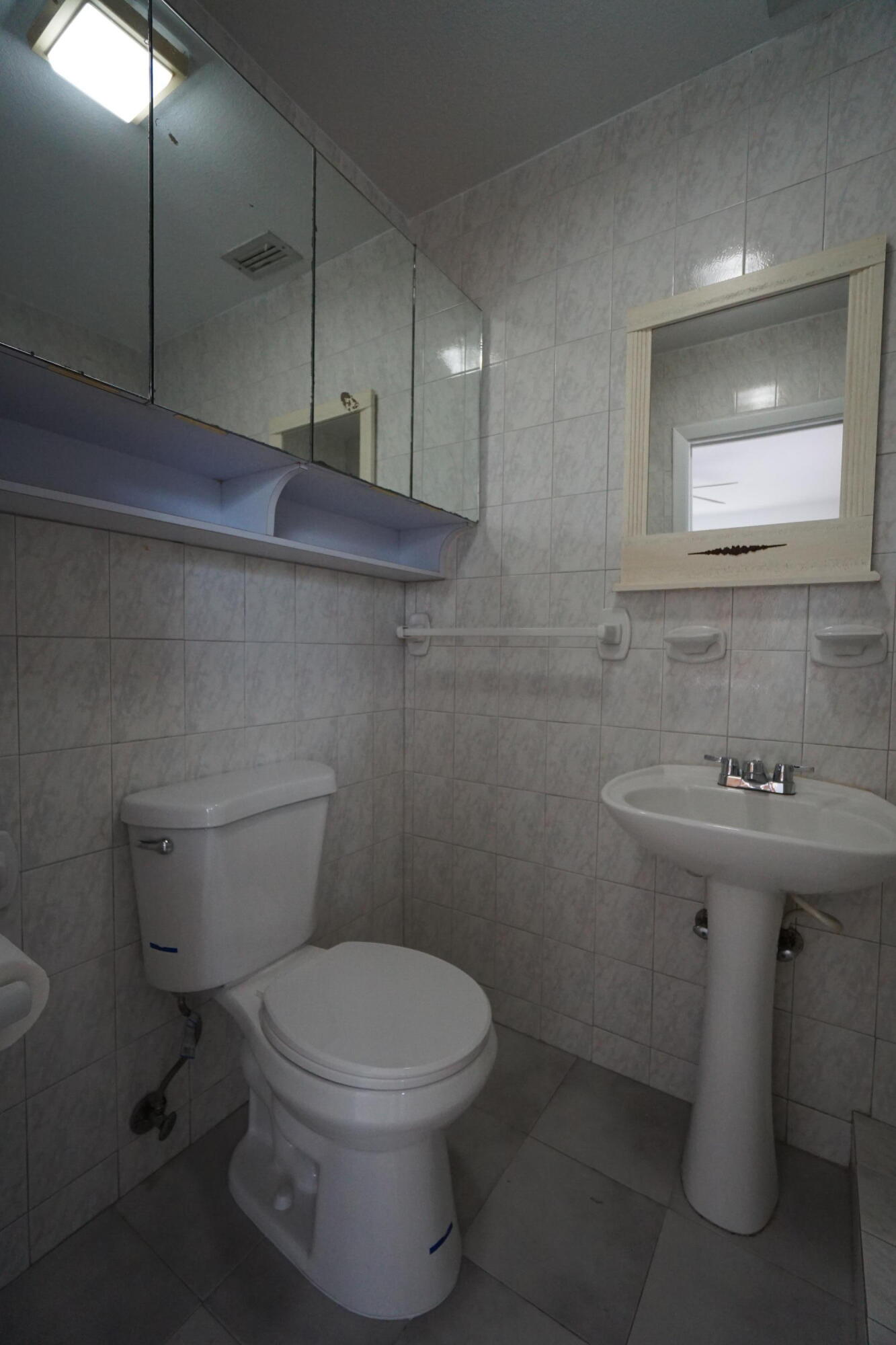 15520 Southwest 302nd Street Homestead, FL 33033 - Photo 10 of 20 a bathroom with a sink a toilet and mirror