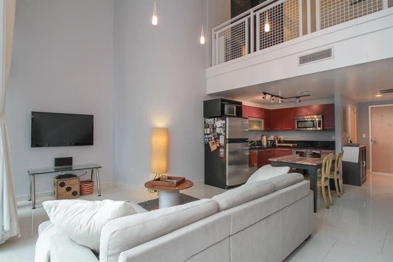 253 Northeast 2nd Street, Unit 421 Miami, FL 33132 - Photo 11 of 39 a living room with furniture and a flat screen tv