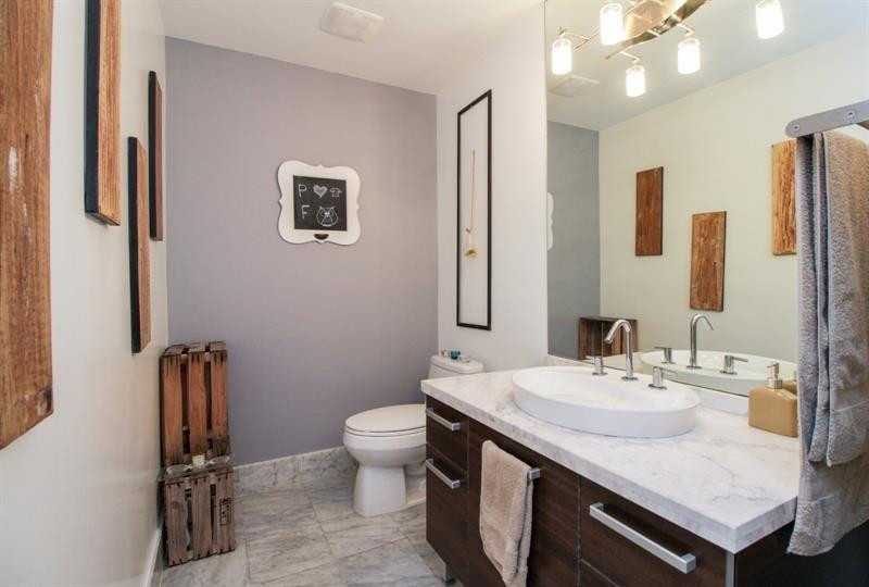 253 Northeast 2nd Street, Unit 421 Miami, FL 33132 - Photo 14 of 39 a bathroom with a sink a toilet and mirror