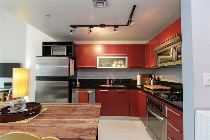 253 Northeast 2nd Street, Unit 421 Miami, FL 33132 - Photo 15 of 39 a kitchen with stainless steel appliances granite countertop a stove a sink and a microwave