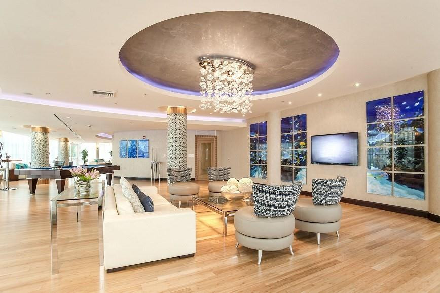253 Northeast 2nd Street, Unit 421 Miami, FL 33132 - Photo 3 of 39 a living room with furniture and a chandelier