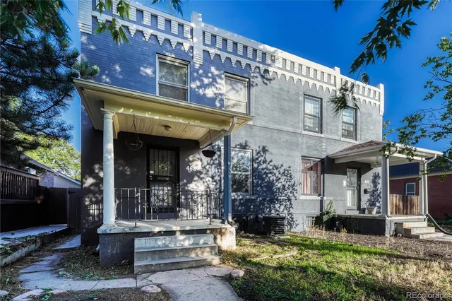 a front view of a building with a garden