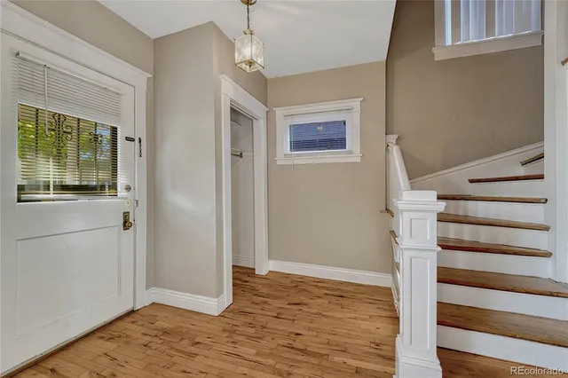 a view of an entryway with wooden floor and door