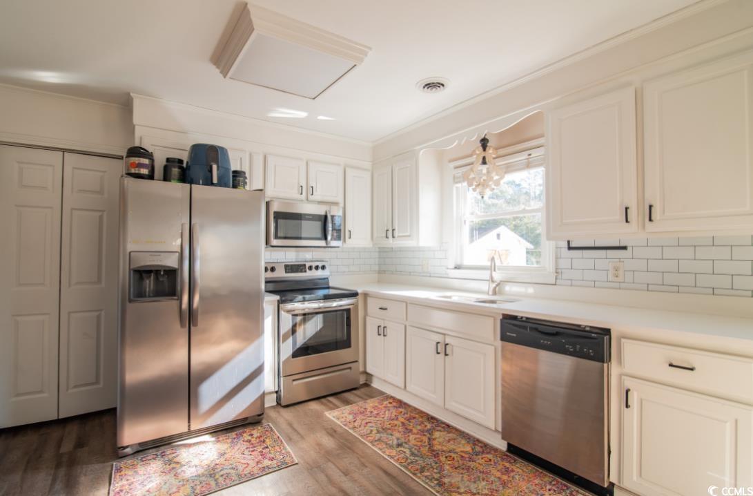 467 Harrelson Road Georgetown, SC 29440 - Photo 10 of 40 Kitchen with white cabinets, sink, appliances with