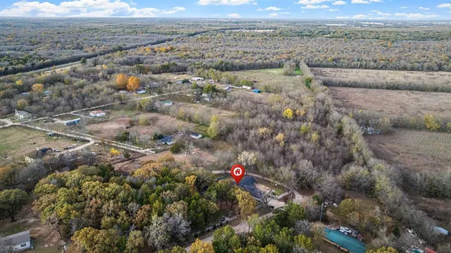an aerial view of a house with a yard