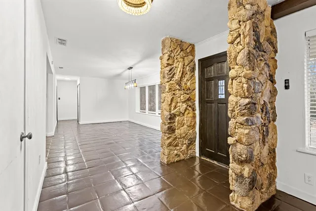 a view of an empty room with a fireplace and a large window
