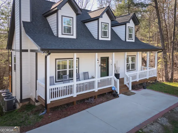 a view of a house with a yard and deck