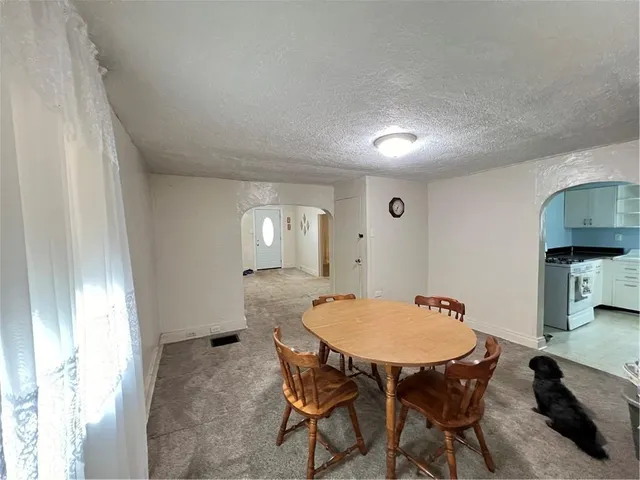 a view of a dining room with furniture and window