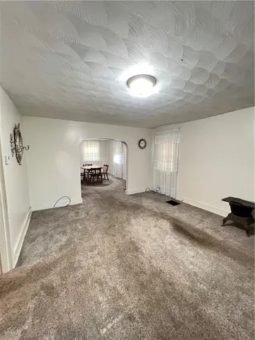 an empty room with a empty space and windows