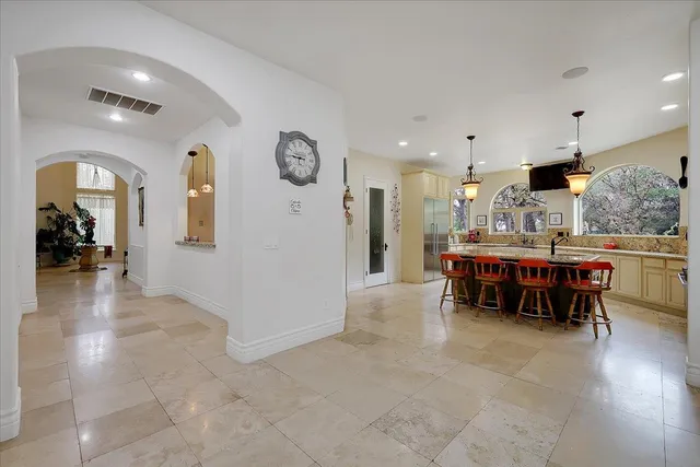 a dining room with furniture and a chandelier