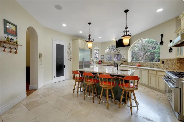 a large kitchen with a table and chairs