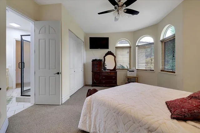 a bedroom with a large bed and a chandelier