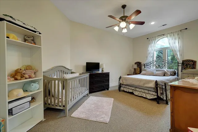 a bedroom with a bed and a chandelier