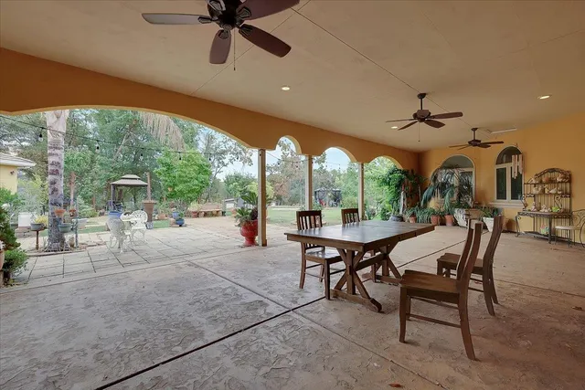 a view of a patio with a table and chairs