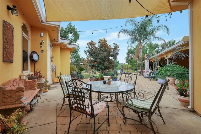 a view of an outdoor space with a table and chairs