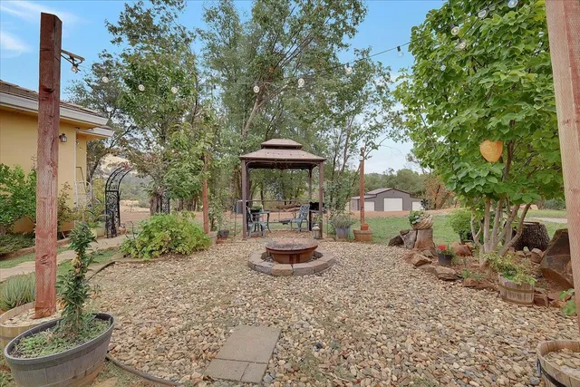 a view of a patio with furniture and a fire pit