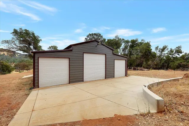 a backyard of a house with large trees