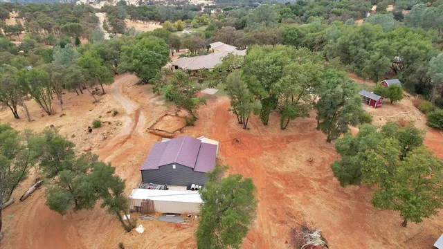 an aerial view of a house with a yard
