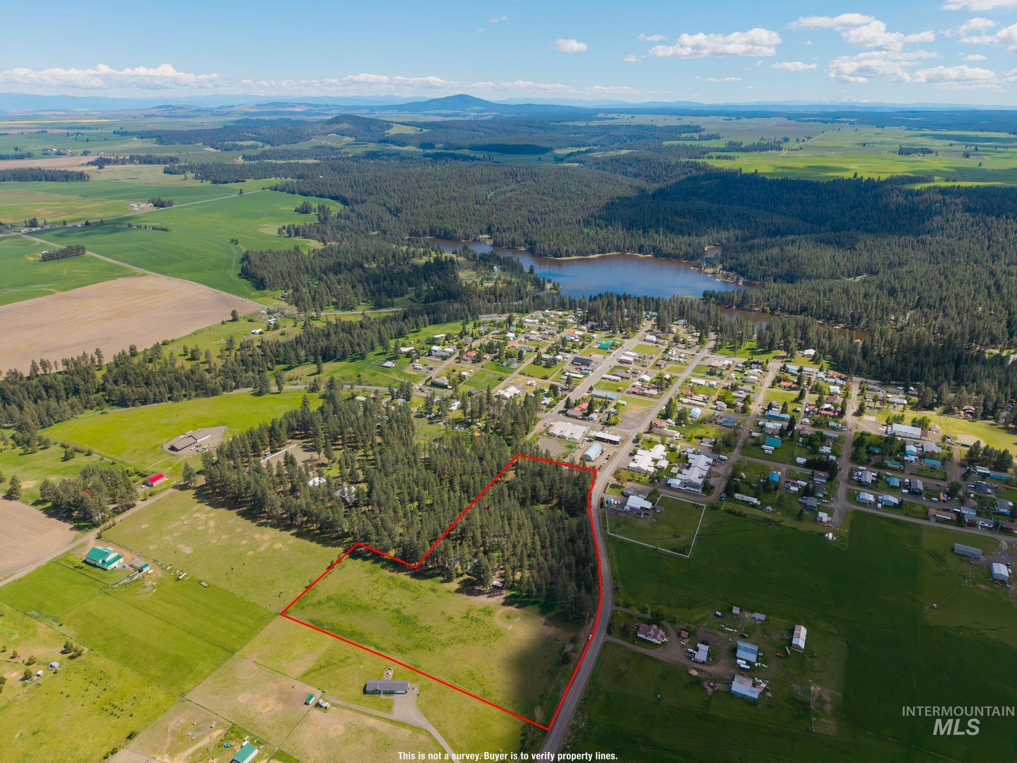 1820 Winchester Road Winchester, ID 83555 - Photo 44 of 50 Expansive parcel featuring a mix of cleared land and mature trees, with a distant lake and mountainous terrain