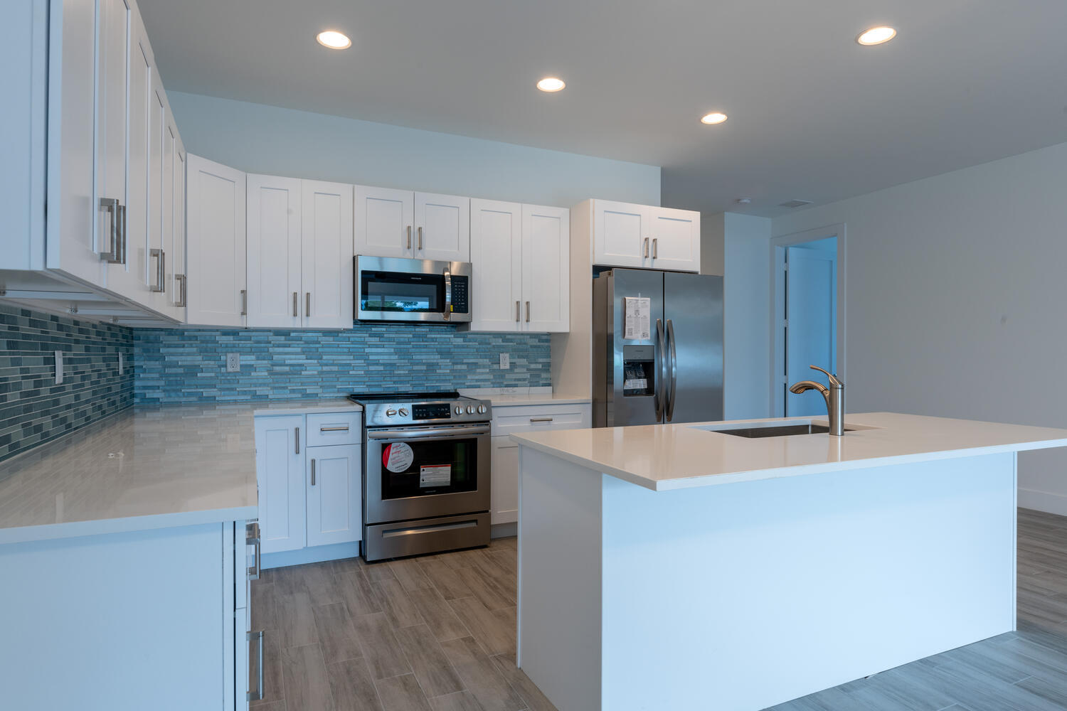 18302 Limestone Creek Road Jupiter, FL 33458 - Photo 2 of 12 a kitchen with kitchen island granite countertop a stove and a refrigerator
