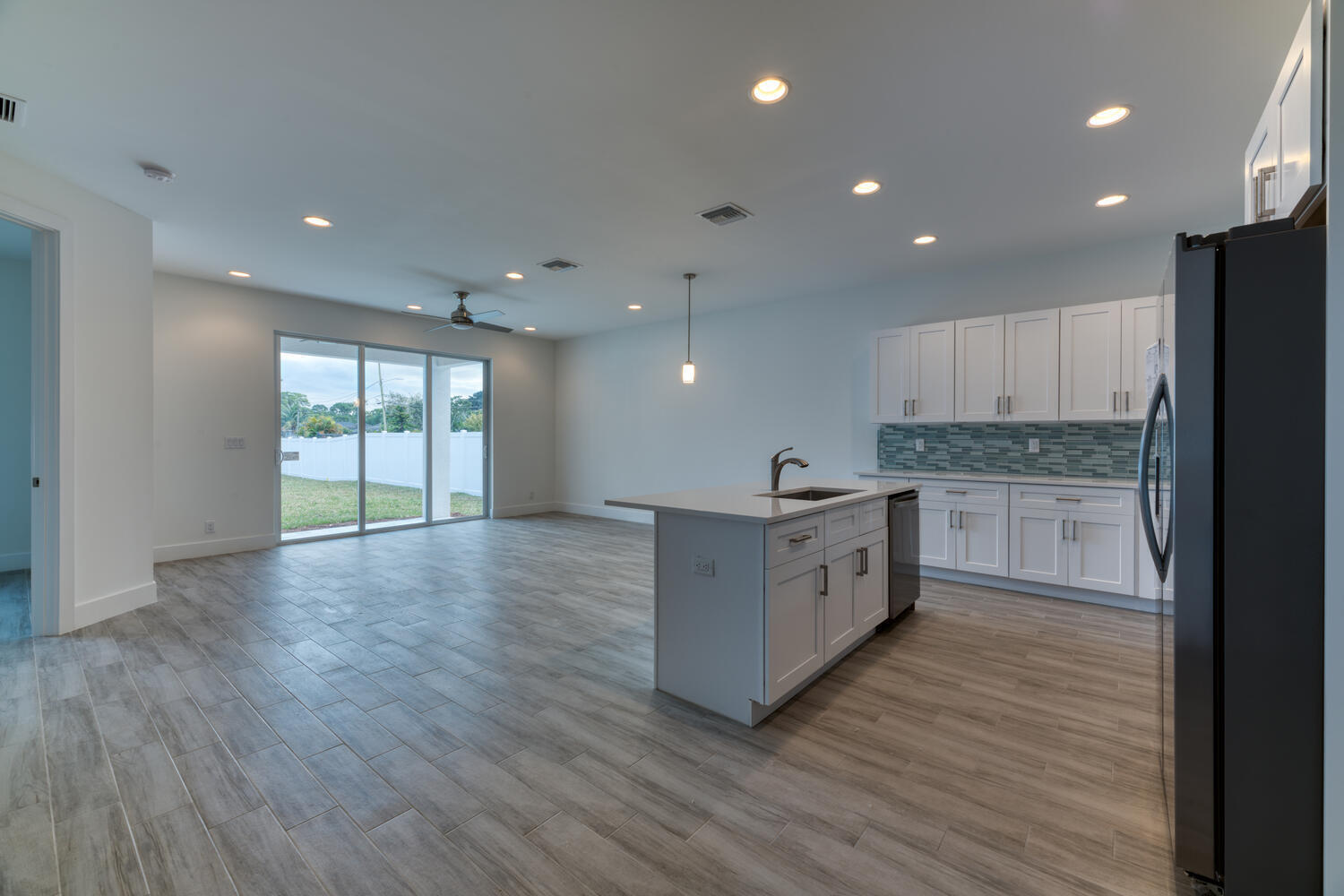 18302 Limestone Creek Road Jupiter, FL 33458 - Photo 3 of 12 a large kitchen with stainless steel appliances granite countertop a large counter top and a stove top oven