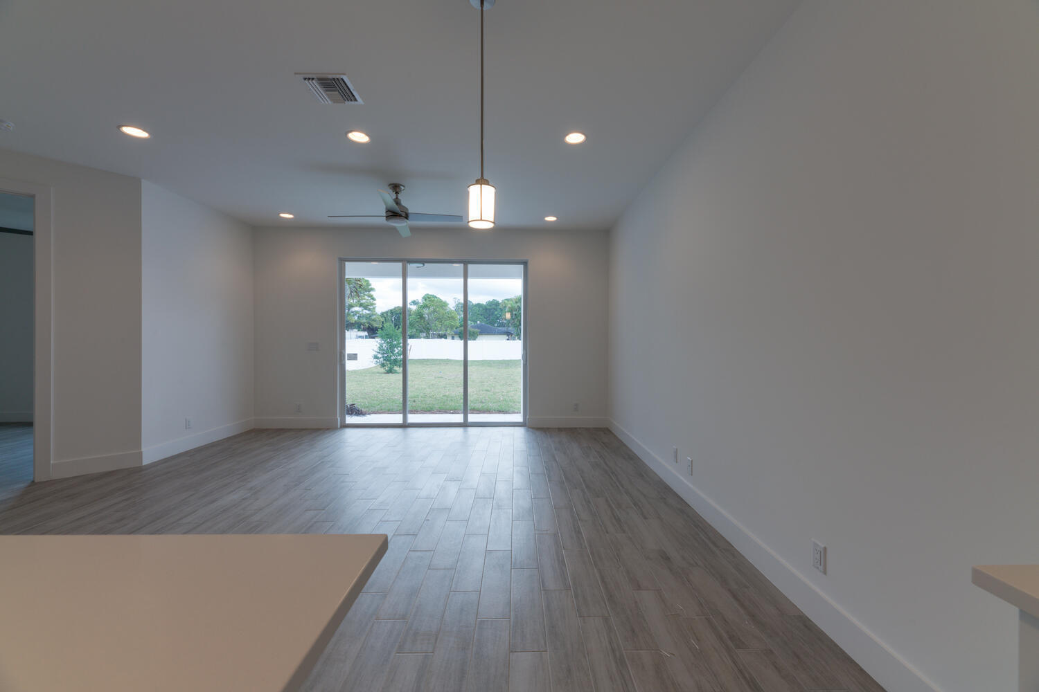 18302 Limestone Creek Road Jupiter, FL 33458 - Photo 5 of 12 an empty room with wooden floor and windows