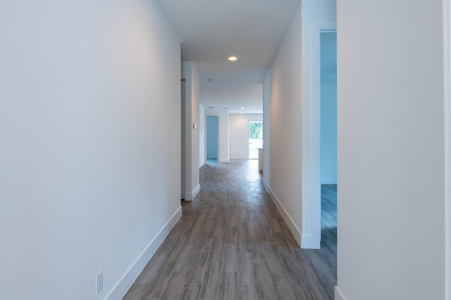 18302 Limestone Creek Road Jupiter, FL 33458 - Photo 8 of 12 a view of a hallway with wooden floor