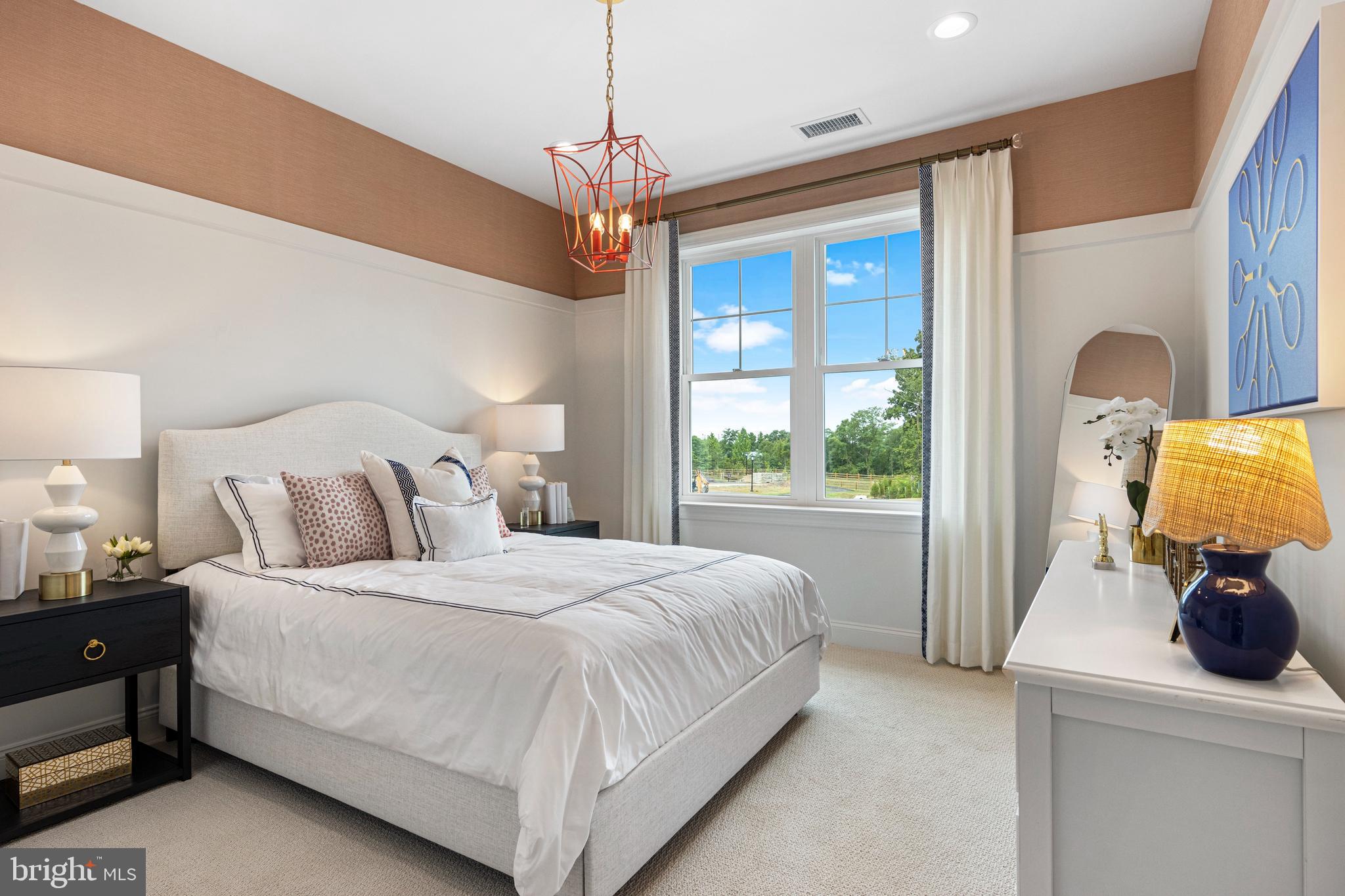 403 Reagans Lane, Unit 72 Chalfont, PA 18914 - Photo 8 of 12 a bedroom with a large bed and a chandelier