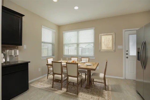 a view of a dining room with furniture and a window