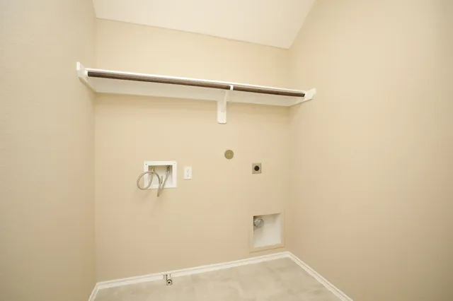 an empty room with a chandelier fan and a ceiling fan