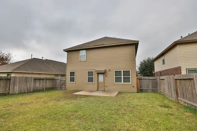 a view of a backyard with wooden fence