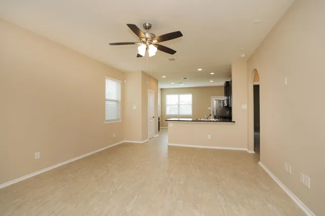 a view of a livingroom with a ceiling fan and window
